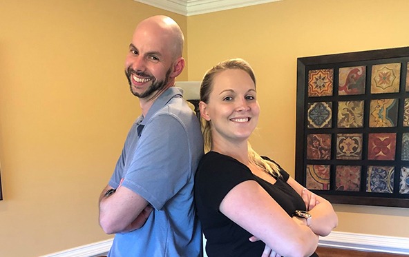 Two smiling dental team members