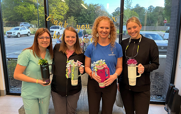 Two smiling dental team members