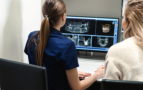Dental team members looking at digital x-rays