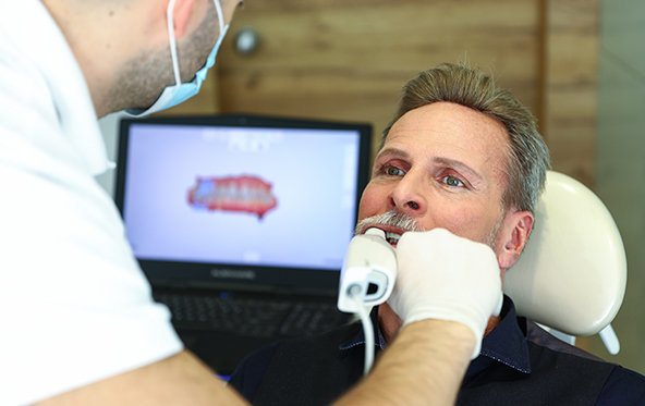 Dentist capturing bite impressions using digital impression system