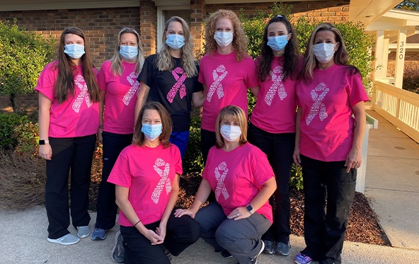 The Langworthy Family Dentistry team wearing breast cancer awareness shirts