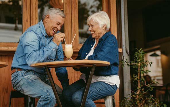 Senior couple with dentures in Fuquay-Varina sharing a milkshake