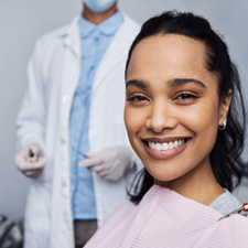 Woman smiling while sitting in treatment chair