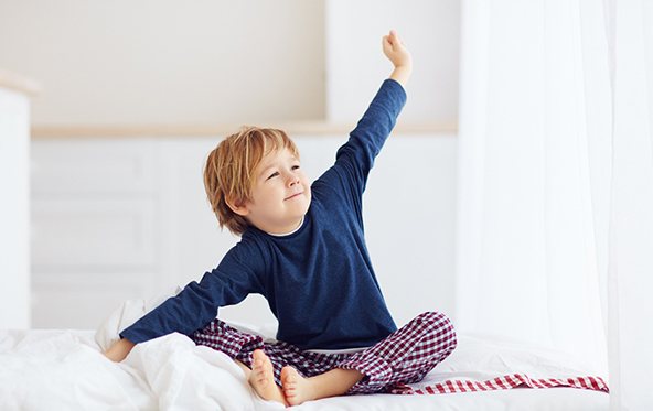 Little boy waking up refreshed thanks to HealthyStart® treatment