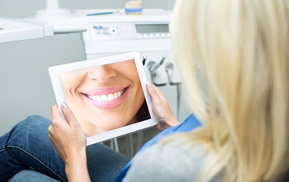 Woman looking at digital imaging on tablet computer screen