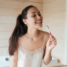 Woman holding a toothbrush