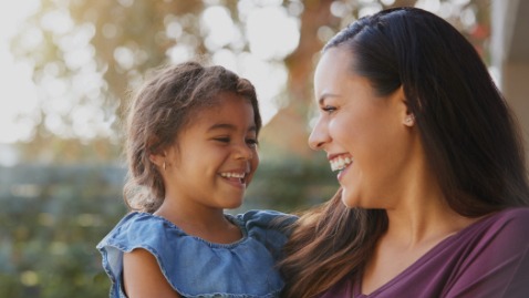 Mother and daughter smiling together after preventive dentistry