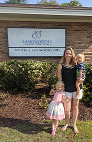 Doctor Langworhty and her children in front of the dental office