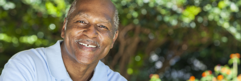 Man smiling with missing front tooth before replacement