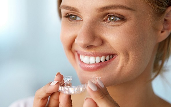 young woman with teeth whitening tray