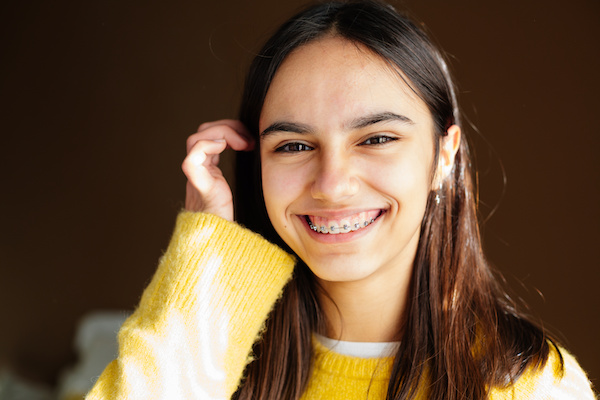 young woman smiling with sun on face