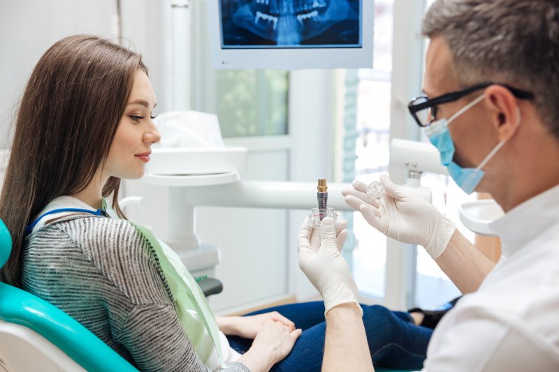Dentist talking with patient at a dental implant consultation