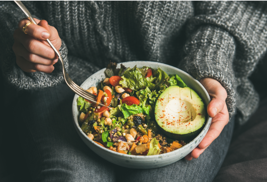 Close up of woman's hands holding salad bowl